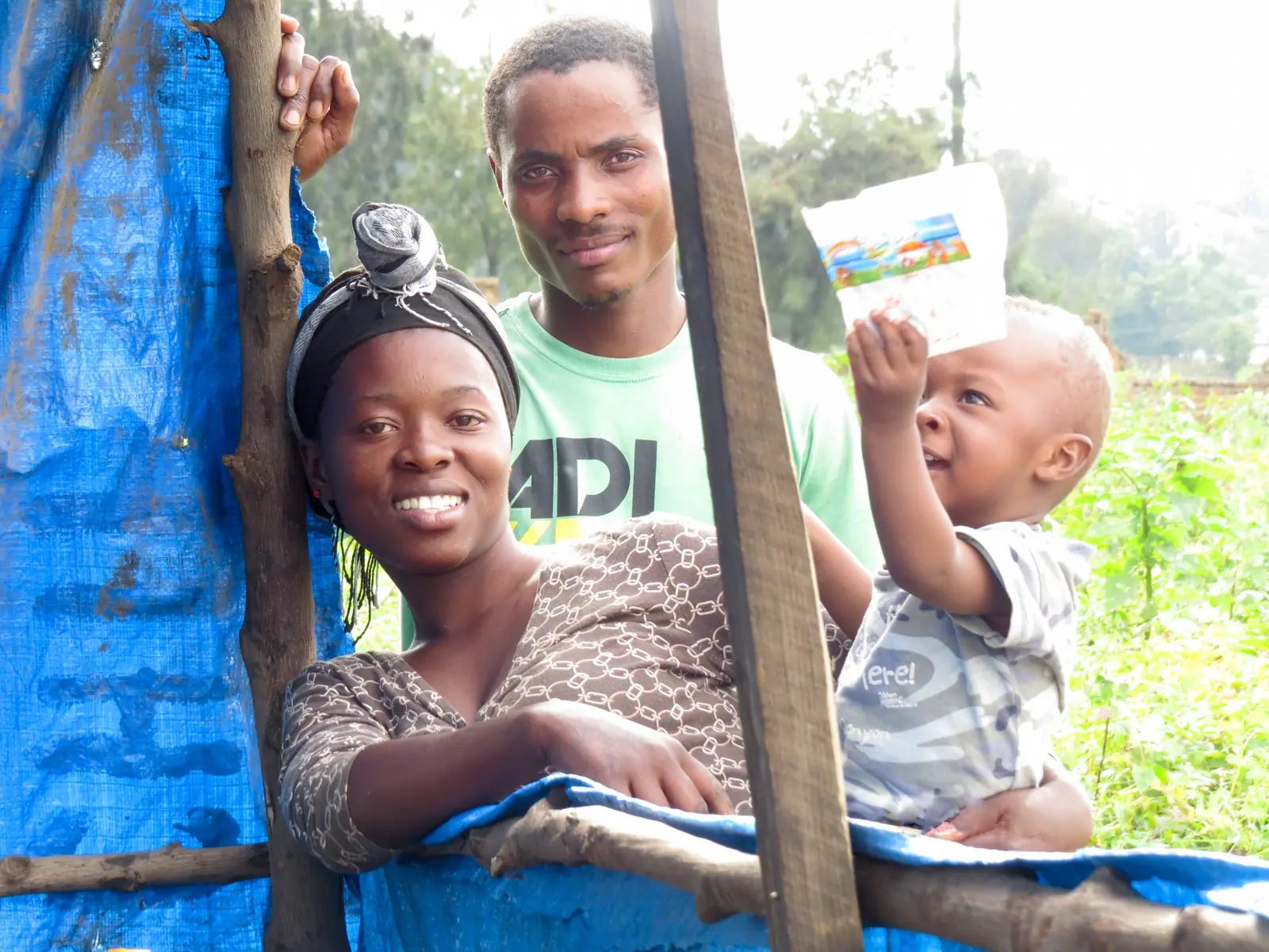 Smiling mother, father and toddler together outdoors in Tanzania